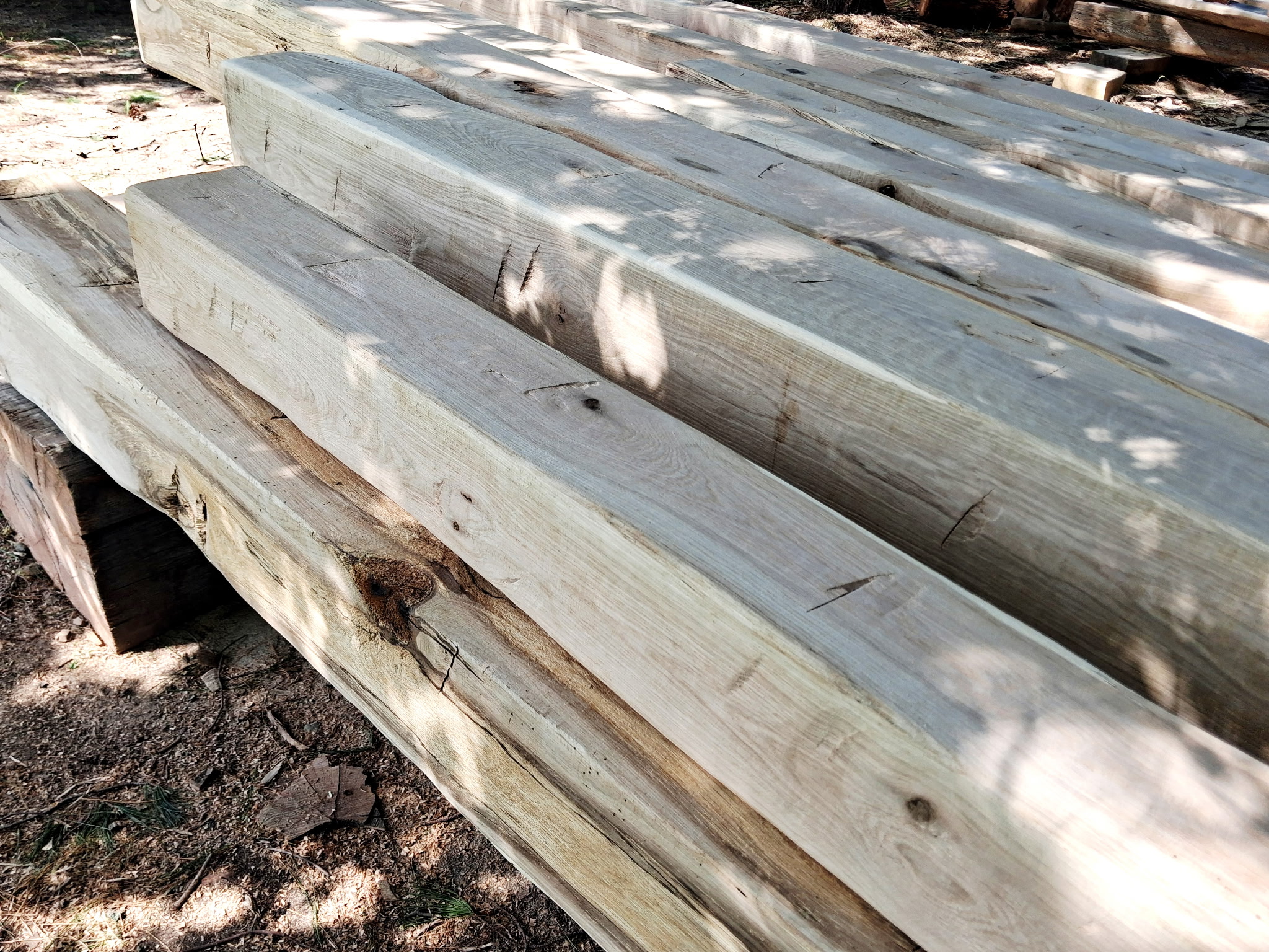 Hand-hewn architectural beam cross-section and face grain